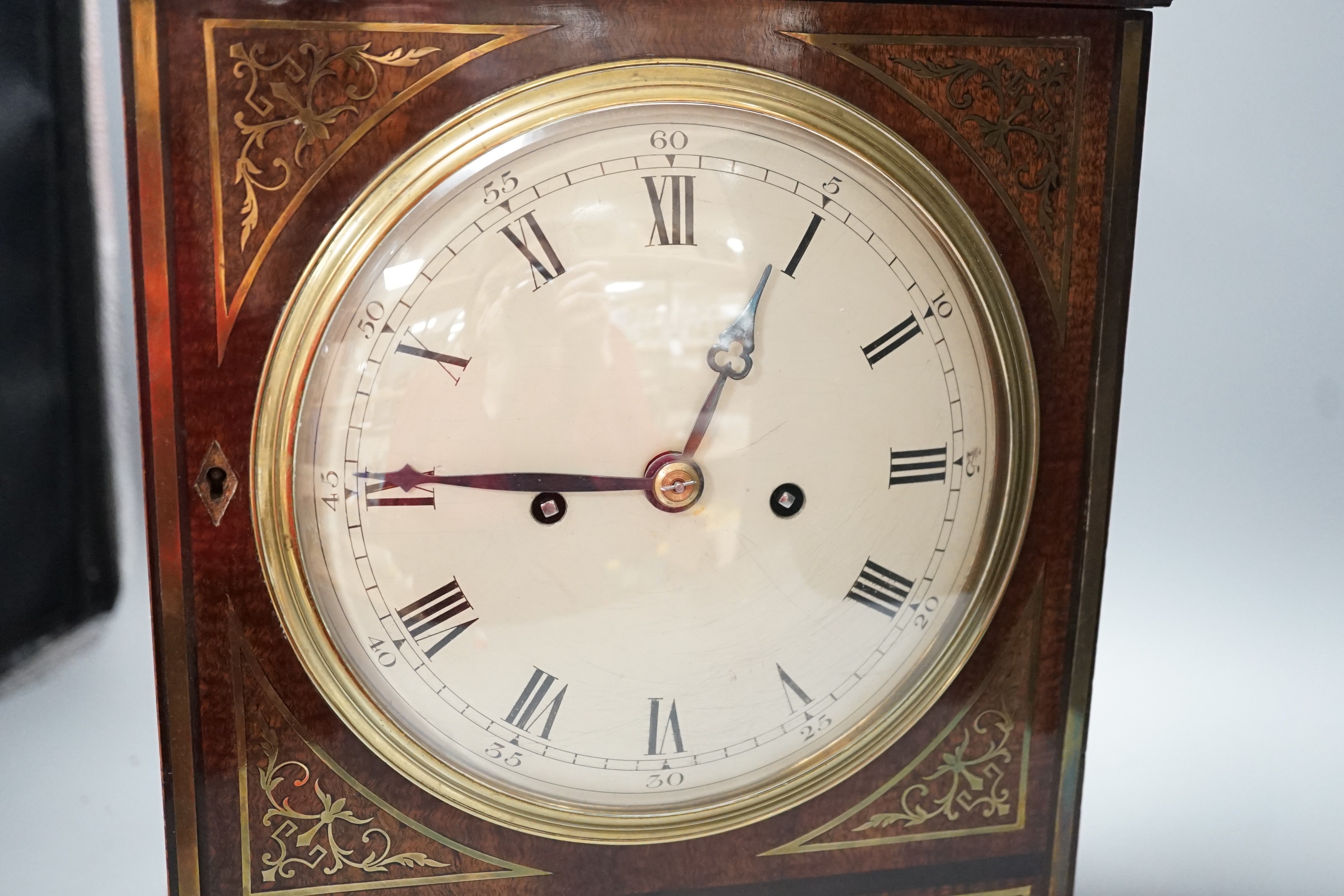 A Regency brass inlaid mahogany bracket clock, with pineapple finial, bears interior paper label Cuss & Co. 49cm high